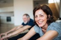 A senior couple indoors at home, doing exercise on the floor. Royalty Free Stock Photo