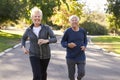 Senior Couple Jogging Through Park Royalty Free Stock Photo