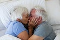 Senior couple kissing each other in bedroom