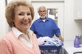 Senior Couple With Laundry In Bathroom