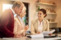 Senior couple, lawyer and paperwork in discussion for budget or retirement plan at home. Happy elderly man and woman Royalty Free Stock Photo