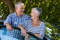 Senior couple leaning on car door Royalty Free Stock Photo
