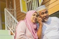 Senior couple listening to a call on mobile phone