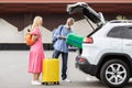 Senior couple loading luggage into car trunk Royalty Free Stock Photo