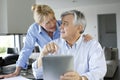 Senior couple looking at bank account on tablet Royalty Free Stock Photo