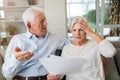 Senior couple looking through bills Royalty Free Stock Photo