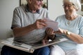 Senior couple looking at family photo album Royalty Free Stock Photo