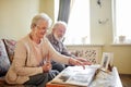 Senior couple looking at family photo album Royalty Free Stock Photo