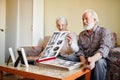 Senior couple looking at family photo album Royalty Free Stock Photo