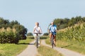 Senior couple looking forward with confidence while riding bicyc Royalty Free Stock Photo