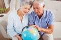 Senior couple looking at a globe Royalty Free Stock Photo