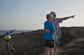 Senior couple looking at the horizon over water at sea. Two retiree enjoying excursion with their bicycles. Activity and wellness Royalty Free Stock Photo