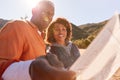 Senior Couple Looking At Map As They Hike Along Trail In Countryside Together Royalty Free Stock Photo