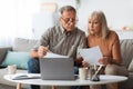 Senior Couple Looking Through Papers Counting Reading Bills At Home Royalty Free Stock Photo