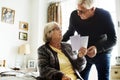 Senior couple looking at photos in the room together Royalty Free Stock Photo