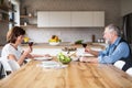 Senior couple in love having lunch indoors at home, talking. Royalty Free Stock Photo