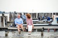 Senior couple on a holiday sitting by the lake, talking. Royalty Free Stock Photo