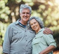 Senior couple, love and hug in nature together for support, care and smile in outdoor park. Portrait of joy, happiness Royalty Free Stock Photo