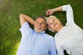 Senior couple lying on grass Royalty Free Stock Photo