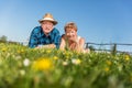 Senior couple lying on the summer field in green grass Royalty Free Stock Photo