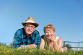 Senior couple lying on the summer field in green grass Royalty Free Stock Photo