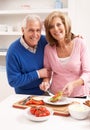 Senior Couple Making Sandwich In Kitchen Royalty Free Stock Photo
