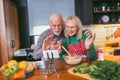 Senior couple making video call on phone in modern kitchen Royalty Free Stock Photo