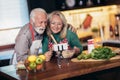 Senior couple making video call on phone in modern kitchen.Quarantine. Royalty Free Stock Photo