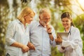 Senior couple talking to nurse or caregiver. Royalty Free Stock Photo