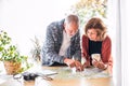 Senior couple with map at home, making plans. Royalty Free Stock Photo