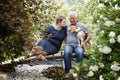 Senior couple, mature man and woman outdoors, with dog pet Royalty Free Stock Photo