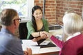 Senior Couple Meeting With Financial Advisor In Office Royalty Free Stock Photo