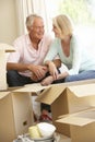 Senior Couple Moving Home And Packing Boxes Royalty Free Stock Photo