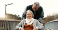 Senior couple, nature and in a wheelchair on a walk for happiness, retirement date or love. Smile, talking and an Royalty Free Stock Photo