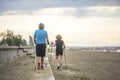 Senior couple nordic walking on the beach.