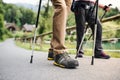 Senior couple with nordic walking poles hiking in nature, midsection. Royalty Free Stock Photo