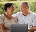 Senior couple online with a laptop at home, laughing and watching movies. A relaxing weekend for a modern elderly couple Royalty Free Stock Photo