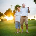 Senior couple out playing golf together portrait Royalty Free Stock Photo