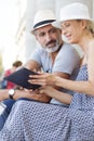 senior couple outdoors looking at electronic tablet Royalty Free Stock Photo