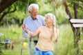 Senior couple outdoors with tree swing Royalty Free Stock Photo