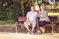Senior couple in the park smiling while feeling happy together