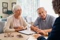 Senior couple planning their investments with financial advisor Royalty Free Stock Photo