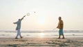 Active senior couple playing tai chi ballon ball at the beach. Royalty Free Stock Photo