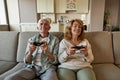 Senior couple playing video game with joysticks Royalty Free Stock Photo