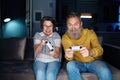 Senior couple playing video games together at home Royalty Free Stock Photo