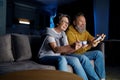 Senior couple playing video games together at home Royalty Free Stock Photo