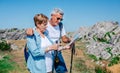 Senior couple with poles hiking looking map