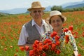 Senior couple on the poppy field enjoying summer Royalty Free Stock Photo