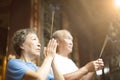 Senior couple praying buddha with incense stick Royalty Free Stock Photo