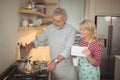 Senior couple preparing food in kitchen Royalty Free Stock Photo